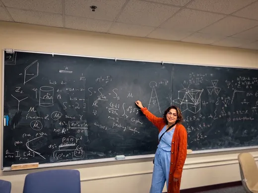 Sweta Mukherjee teaching a student at a whiteboard